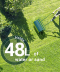 Person using Heavy Duty Push Or Tow Behind Garden Roller Water Or Sand Filled Drum Roller For Lawn Yard Park And Ball Field 13x24 Inch Steel Frame Turf Stabilizer No Power Quiet Green Finish on grass