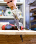Japanese Keyhole Saw With Coarse Teeth For Lightning Fast Curved Cuts, crafted around a sturdy red oak grip, cutting wood.