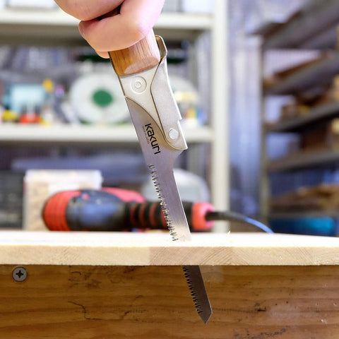 Japanese Keyhole Saw With Coarse Teeth For Lightning Fast Curved Cuts, crafted around a sturdy red oak grip, cutting wood.