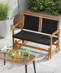 Two Person Wooden Outdoor Glider Bench With Acacia Wood Armrests And Wicker Back And Seat Rocking Patio Loveseat in patio setting