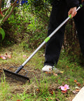 Person using 65 Inch Bow Rake For Heavy Duty Garden Work With 17 Tine Metal Head And High Strength Adjustable Handle on grass.