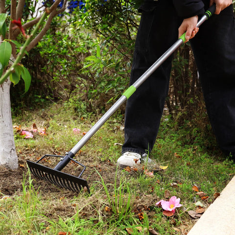 Person using 65 Inch Bow Rake For Heavy Duty Garden Work With 17 Tine Metal Head And High Strength Adjustable Handle on grass.