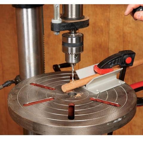 Top Notch Drill Press Table V Block Accessory Offers Sweet Support For Round Stock And Dowels bolted to a drill press table.