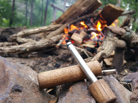 Hickory Fire Piston Kit With Char Cloth O Rings Instructions And Storage Bag For Quick Campfire Lighting tool on rocks