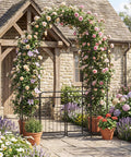 87 Inch Metal Garden Arch With Lockable Gate And Side Shelves Built Tough Arbor Trellis For Climbing Plants Outdoors Includes 6 Ground Stakes Decorative Entrance Archway For Patio And Lawn Black covered in flowers