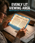 Person reading newspaper using 5X Rechargeable LED Page Magnifier With Large 4.5 By 7 Inch Viewing Area Anti Glare Lens And 3 Color Light Modes