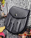 Dope Renaissance Scottish Medieval Faux Leather Sporran Pouch Bag Black with adjustable strap against tree roots