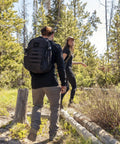 Person hiking with a Wakizashi Tactical Backpack 24L With MOLLE System Durable 100 Percent Polyester Gear Pack 17.1 By 11.1 By 6.1 Inches Black