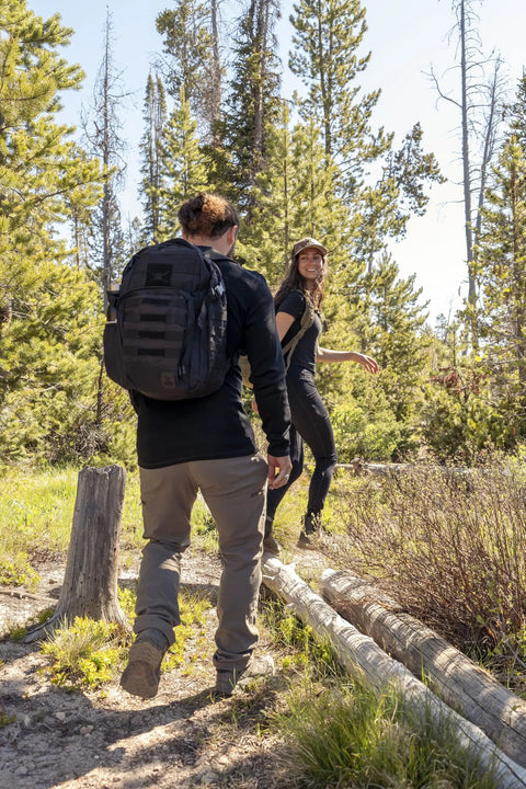 Person hiking with a Wakizashi Tactical Backpack 24L With MOLLE System Durable 100 Percent Polyester Gear Pack 17.1 By 11.1 By 6.1 Inches Black
