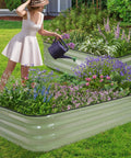 Woman watering plants in Galvanized Raised Garden Bed Kit 5X3X1 Modular Planter Box For Outdoor Gardening in backyard