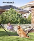 Woman and dog relaxing in a Double Hammock 98.4 X 59.1 Inches With 660 Lb Capacity Breathable Cotton Polyester Fabric Backyard Oasis Lounge.