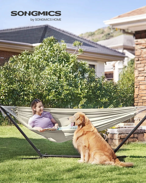 Woman and dog relaxing in a Double Hammock 98.4 X 59.1 Inches With 660 Lb Capacity Breathable Cotton Polyester Fabric Backyard Oasis Lounge.
