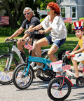 Family riding bikes with Reflective Bike Spoke Covers Set of 72 Pieces Red White Blue Wheel Skins for 4th of July.