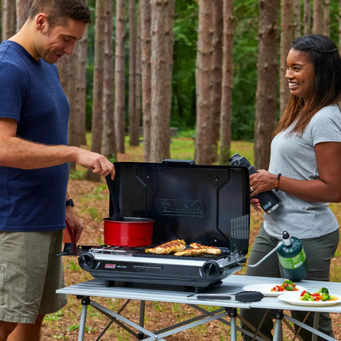 People using 2-In-1 Tabletop Camping Grill And Stove With Two Burners, 20,000 BTUs Of Cooking Power, Adjustable Burners outdoors