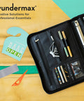 Open black organizer with pens, cards, a gray and orange tool, and a sign saying 'Keep Door Open' on a yellow surface.