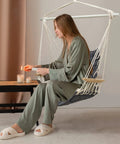 Woman relaxing in Chill Indoor Outdoor Hammock Chair With Wooden Armrests, Steel Spreader Bar And Anti Slip Rings, Cotton Weave Swing
