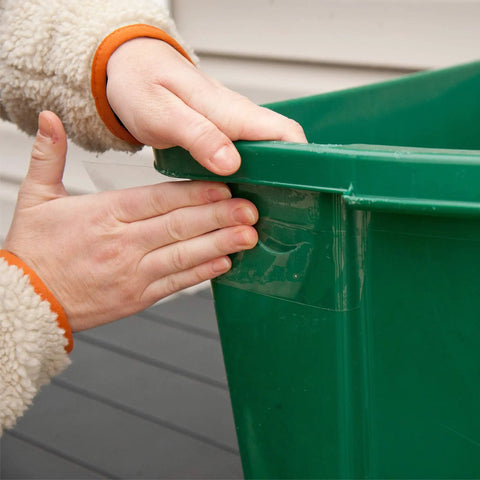Applying Crystal Clear Heavy Duty Duct Tape For Indoor And Outdoor Repairs 2.83 Inch Wide By 15 Yard Roll to a green bin
