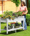 Raised Garden Bed On Wheels With Legs And Lockable Casters, Weather Resistant HDPE Elevated Planter Box, Double Tier Poly Wood Garden Bed For Backyard, Patio Or Balcony, Easy Mobility And Durable Outdoor Use, woman tending plants