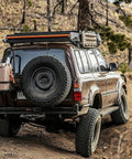 4x4 vehicle with mounted Portable 5 Gallon Military Style Water Jug For Camping And RVs Sand Colored Plastic Beverage And Hydration Dispenser