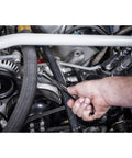 Using Ratcheting 12 Point Combination Wrench One And Thirteen Sixteenths Inch, 72 Tooth Box End in tight car engine space