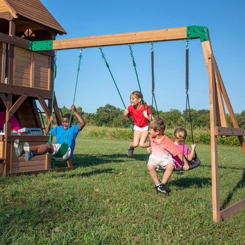 Children playing on Cedar Cove Wooden Swing Set With Spiral Tube Slide And Wave Slide, Elevated Clubhouse With Balcony, Toy Grill And Snack Bar, Rock Wall, Belt Swings, Web Swing, Chalkboard, Ladder For Backyard Playtime