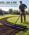 Man using 35 Inch Wide Lawn Leveling Rake With 6.5 Ft Long Handle, Heavy Duty Yard Leveler And Workhorse For Dirt And Sand on grass
