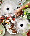 Fly Swatter And Battery Powered Food Spinning Fans Set Of 2 for tables with safe soft blades above picnic food on a table.