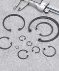 Heavy Duty 20 Pack 47Mm Internal Retaining Ring Circlips Forged From 65Mn Spring Steel Featuring Black Oxide Finish arranged with caliper.