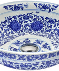 Decorative blue and white floral vessel sink bowl, viewed from above, with intricate patterns on the interior surface.