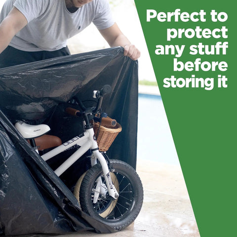 Person placing a bicycle into 95 Gallon Extra Large Trash Bags 61x68 Inches 1.2 Mil Thick Beefy Heavy Duty Contractor Bags For Outdoor Waste Storage Landscaping Custodial Use 25 Count Made In USA.