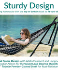 Universal Outdoor Hammock Stand Heavy Duty 550 Pound Capacity With Adjustable Length Fits 9 To 14 Foot Hammocks Including Mayan Brazilian Camping And Spreader Bar Styles Black Chains And Hardware Included with person relaxing by a lake.