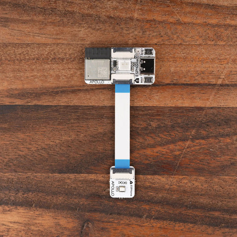 Plug And Play Smart Home Sensor Hub Delivered As A Straight Up Game Changer For Quick Home Assistant Setup With Zero Sweat Soldering Required And Dual Expansion Ports Linked To A Visual Device Builder For Smooth Local Control, showing a compact sensor module with ribbon cable on wooden surface.