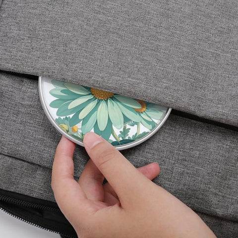 Mint Green Watercolor Daisy Wireless Charger Pad With 10W Fast Charging Portable Qi Charger Pad being placed in a bag