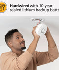 Man installing 2 In 1 Smoke Detector And Indoor Air Quality Monitor With WiFi And Alexa Compatibility Hardwired With Battery Backup