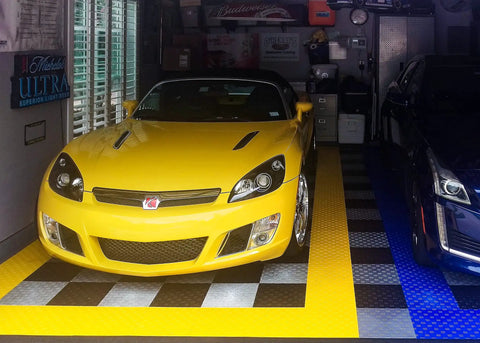 Yellow car parked on Interlocking Garage Floor Tiles Diamond Pattern Non Slip Heavy Duty Copolymer 12X12 Inch Modular Tiles 48 Pack