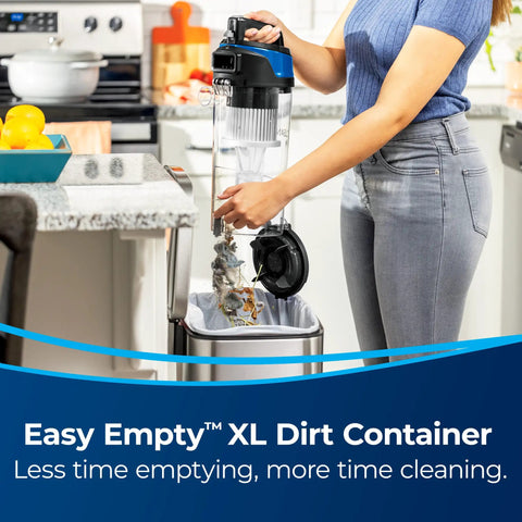 Woman using Easy Empty™ XL Dirt Container from Straight Up Powerful Upright Vacuum Cleaner for emptying debris into trash.