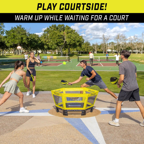 People playing on a court with Pickle 360 Outdoor Paddle Ball Game Set For Lawn Beach And Backyard No Court Needed 2 On 2