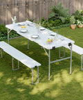 Picnic Table Set With 2 Benches, 6 Feet Folding Camping Table And Chairs, Wood Grain Top, Grab And Go, set up in a garden.