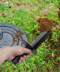 Heavy Duty Serrated Metal Detecting Shovel With Belt Mount Sheath for Treasure Hunting and Gardening in use on grassy soil
