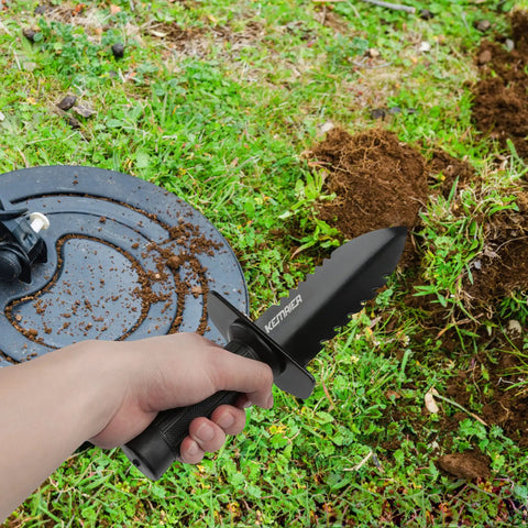 Heavy Duty Serrated Metal Detecting Shovel With Belt Mount Sheath for Treasure Hunting and Gardening in use on grassy soil