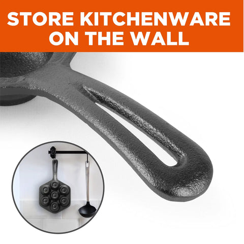 Close-up of Seven Section Cast Iron Danish Aebleskiver Pan handle, shown hanging on a kitchen wall with ladle.