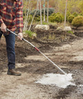 Person using Heavy Duty Watering Wand Sprayer For Garden Hose With Adjustable Tip Rugged Metal Construction Soft Grip Handle