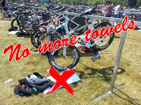 Bikes in crowded triathlon transition area, Large Neoprene Triathlon Transition Mat Teal Blue For Crowded Transitions Wetsuit Changing Pad visible on ground