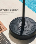 Fillable Round Sunburst Umbrella Base Stand With 55 Pound Weight Capacity, Plastic Patio Pole Holder next to pool.