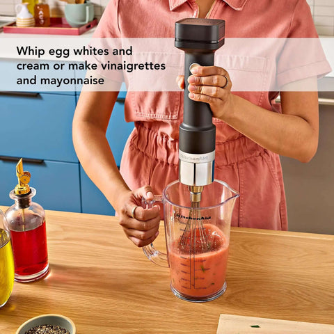 Wireless Stick Blender Set With Whisk No Cords Attached 7 Inch Blending Arm Stainless Steel Blade in use for mixing vinaigrette.