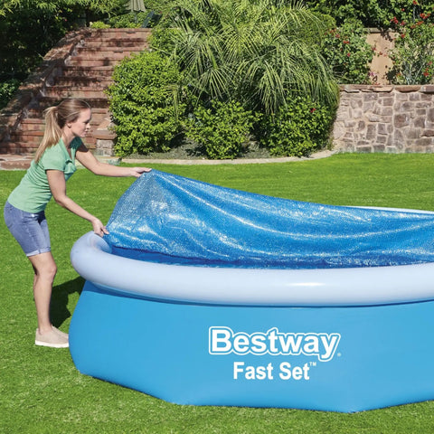 Woman placing Hella Effective 10 Foot Solar Pool Cover That Locks In Heat And Shields Against Debris on inflatable pool.