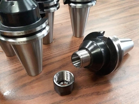 CAT40 ER16 Collet Chucks 8 Piece Heavy Duty Set for CNC Milling Centers displayed on wooden surface