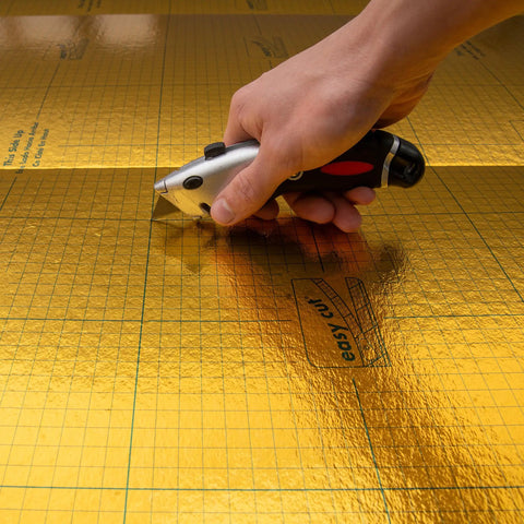 Premium Flooring Underlayment Roll 100 Sq Ft 2Mm Thick with PreTaped Sides being cut with a utility knife.