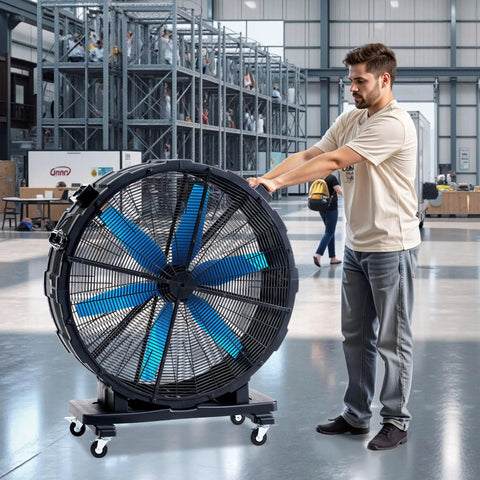 Person adjusting a 48 Inch Industrial Drum Fan With 17,660 CFM High Velocity Airflow, 750W Copper Motor on wheels in a factory.