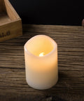 12 Pack Flameless Candles With Real Wax Battery Operated LED Pillar Candles Unscented Ivory Color Including Remote Control And 24 Hour Timer Diameter 3 Inches Height 4 Inches Perfect For Cozy Home Vibes Parties Weddings And Events on wooden table